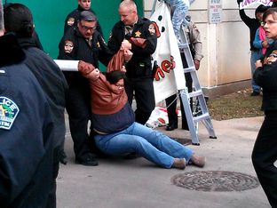 Cristina Parker gets arrested during a protest against the Secure Communities program.