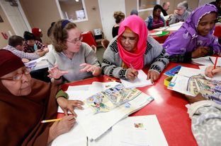 Volunteer Jennifer Butler, second from left, works with Somali immigrants Saharlo Adlle, from left, Zainab Botnb and Ikyan Seer during an English as a second language class at an apartment complex in Amarillo on Feb. 15.
