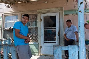 L to R: Martin Gomez Jr. and his father Martin Gomez Sr. both work, but make so little that they aren't interested in buying healthcare insurance. The Gomez family lives in a colonia near Alton.