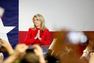 State Sen. Wendy Davis, D-Fort Worth, takes the stage as supporters at her Fort Worth headquarters cheer her victory in the primary election.