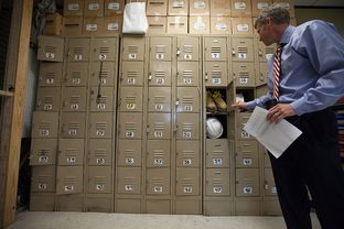 Parc Smith, CEO of American YouthWorks, a dropout recovery charter school facing closure by the state, looks in a student locker.