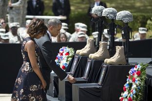 President Barack Obama and First Lady Michelle Obama pay respects to soldiers killed during a Fort Hood ceremony on April 9, 2014.