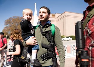 Chris Way and his son Ryan, 2, participate in a march during South by Southwest in March 2014, an event led by the Austin chapter of the gun rights group Come and Take It.