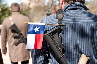Gun rights supporters participate in an open carry march through South by Southwest led by the Austin chapter of Come and Take It on Wednesday, March 12.