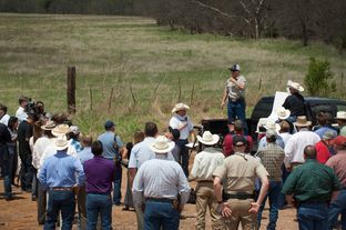 Texas landowner Tommy Henderson speaks to a gathering of politicians, landowners and others at a bridge over the Red River near Byers, Texas, on April 28, 2014.