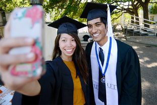 University of Texas at Austin economics majors Alexis Guevara and Ahmed Quadri capture a graduation day moment for posterity on May 5, 2014.