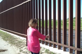 Eloisa Tamez stands near the border fence built on land formerly owned by her family.
