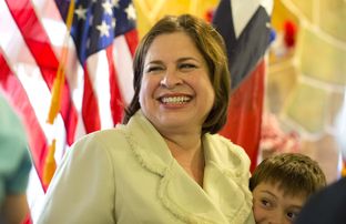 State Sen. Leticia Van de Putte D-San Antonio, the 2014 Democratic candidate for lieutenant governor, hugs one of her grandsons during a campaign event on June 4, 2014, in Austin.