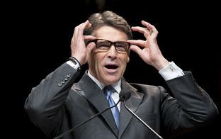 Gov. Rick Perry points out his new glasses in a speech to the Texas Republican Convention on June 5, 2014.