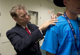 Kentucky Sen. Rand Paul signs a delegate's shirt at the State Republican Convention in Fort Worth on June 6, 2014.