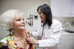 Physician Christine Le, an osteopathy specialist at the Kelsey-Seybold Clinic in Houston, checks up on her patients Mary Ann Goolsby and her husband Joseph Goolsby, Tuesday June 10, 2014.
