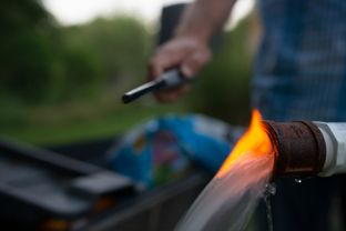 Steve Lipsky shows the methane contamination of his well by igniting the gas with a lighter outside his family's home in Parker County near Weatherford on June 17.