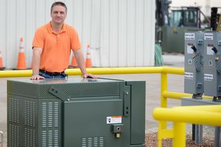Chris Schein of Oncor stood with one of the company's new batteries at Oncor's Environment System Operating Services Facility near Lancaster on June 12, 2014.