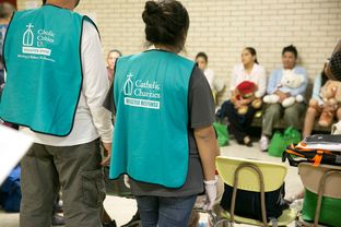 On June 24, 2014, volunteers gather at Sacred Heart Catholic Church in McAllen, where the Rio Grande Valley Catholic Charities have a makeshift shelter to help handle the surge of immigrants who have crossed into the U.S. in recent weeks.