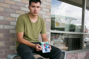Julio Cesar Garcia Duarte, holds a photograph of his common law wife and son at a bus station in McAllen. He was told a "coyote" would deliver them to the Rio Grande but doesn't know their whereabouts.