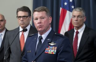 Adjutant General John Nichols of the Texas National Guard explains the Guard's role in helping secure the border as Gov. Rick Perry, l, and DPS Director Steve McCraw listen July 21, 2014.