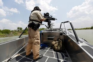 A Texas Parks and Wildlife warden patrols the Rio Grande in July, 2014.