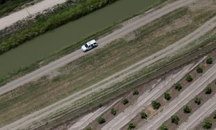 A Customs and Border Protection vehicle patrols on the Texas border near the Rio Grande, Thursday, July 24, 2014, in Mission, Texas. Texas is spending $1.3 million a week for a bigger DPS presence along the border.