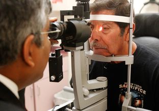 Dr. Alexander P. Sudarshan, an ophthalmologist, examined Jose Juan Herrera, a Vietnam War veteran, last month in Weslaco. Dr. Sudarshan treats patients referred by Veterans Affairs.