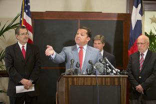 Gov. Rick Perry's legal team, led by Houston attorney Tony Buzbee, c, speaks to the press on August 18, 2014.