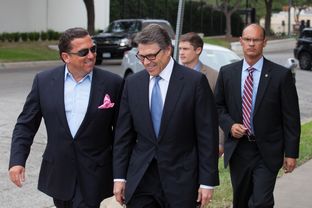 Gov. Perry and his lead attorney, Tony Buzbee, walk to Blackwell-Thurman Criminal Justice Center for his booking on Aug. 19, 2014.