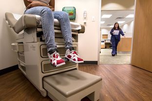 Eighth-grader Montanique DeShay waits as Ashlyn Brooks, medical assistant at MedSpring Urgent Care in Austin, comes to check on her on Wednesday.