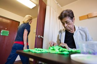 A patient at Sagebrook Health Center, a nursing facility in Cedar Park, kneads putty to build fine-motor coordination and dexterity. Officials from Sagebrook and other facilities have raised concerns about a proposed rule that would have the state close nursing homes found to have the highest-level violations of federal quality standards on three separate days over 24 months.