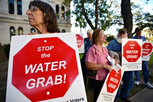 Bastrop County resident Charlotte Gilman protests the Vista Ridge Water Supply Project with other Lee and Bastrop County residents.