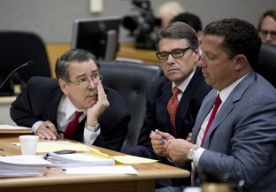 Gov Rick Perry listens as attorneys David Botsford, l, and Tony Buzbee plot strategy in a court hearing on Nov. 6, 2014.