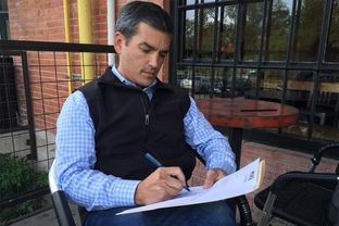 State Rep. Mike Villarreal, D-San Antonio signing letter resigning from state House to run for mayor of San Antonio.