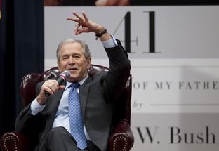 Former President George W. Bush tells a story about his father at Texas A&M University on Nov. 11.