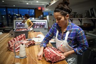 Julia Poplawsky, 26 years old and butcher at Dai Due Butcher Shop & Supper Club in Austin, and her assistant Ashley Chaney, 28, work to prepare cuts of beef on Nov. 11, 2014.