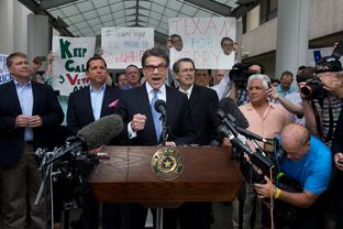 Texas Gov. Rick Perry speaks to supporters after he is booked into the Blackwell-Thurman Justice Center in Austin following his indictment on two felony counts related to defunding District Attorney Rosemary Lehmberg's Public Integrity Unit.