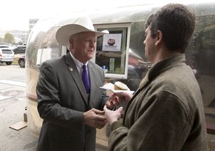 Texas Agriculture Commissioner Sid Miller gives away cupcakes at a press conference on Jan. 12, 2015.