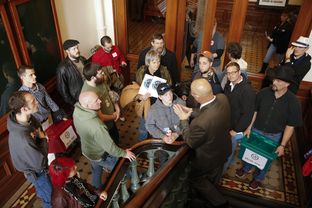 Senate Sergeant at Arms Rick DeLeon tells a group from Lone Star Gun Rights that they are not allowed in the secure back hall of the Senate on opening day Jan. 13, 2015.