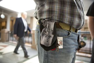 Jason Orsek with Come and Take it America wears a cloth gun holder with a photo of a gun imprinted on it at the Texas Capitol on Feb. 12, 2015, when the Senate Committee on State Affairs heard testimony on gun-related bills.