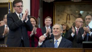 Lt. Gov. Dan Patrick, l, applauds as Texas Gov. Greg Abbott is introduced Feb. 17, 2015 prior to his State of the State speech.