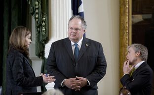 Sen. Craig Estes, R-Wichita, Falls, center, and Sen. Don Huffines, R-Dallas, speak to Karina Davis the Senate Parliamentarian on March 16th, 2015