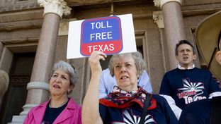 An advocate for restricting funds for toll-roads in Texas attends a rally March 23rd, 2015