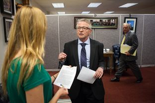 Caomhán Ó Raghallaigh, a transgender advocate, visits with Sarah Byers, left, in the Capitol office of Sen. Kirk Watson, right.
