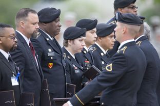 SSG Joy Clark (Nelson), center, and other Purple Heart recipients receive their awards during the Fort Hood ceremony.