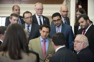 San Antonio Democratic Rep. Trey Martinez Fischer, c, confronts State Rep. Larry Phillips, R-Sherman, with a Point of Order on HB 910 that delayed the open carry gun bill on April 14, 2015.