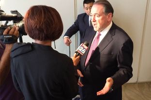 Former Arkansas Gov. Mike Huckabee speaks with a reporter after delivering a speech on energy policy in Houston. The Republican presidential candidate spoke about reducing the United States' dependence on foreign sources of energy.