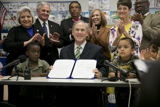 Gov. Greg Abbott signs House Bill 4, which adds funding for pre-kindergarten, into law at the Anita Uphaus Early Childhood Center in Austin on May 28, 2015.