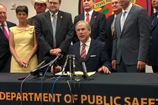 Gov. Greg Abbott celebrates the signing of House Bill 11 at a Texas Department of Public Safety facility in Harris County.