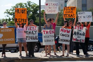 Abortion rights activists protest across from the governor's mansion in Austin on June 9, 2015.