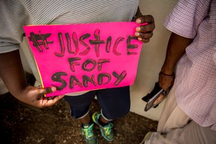 Hempstead resident Adrienne Holland holds a sign outside of the Waller County Jail where Sandra Bland, 28, was found dead.