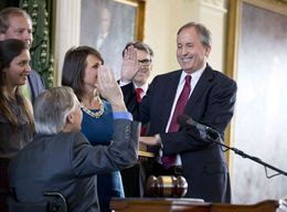 Attorney General Ken Paxton, surrounded by family, takes the oath of office in the Senate chamber on January 5, 2015.