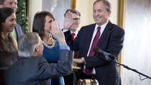 Attorney General Ken Paxton, surrounded by family, takes the oath of office in the Senate chamber on January 5, 2015.