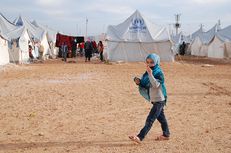 A child walks in a United Nations refugee camp in Turkey where thousands of Syrian refugees reside.